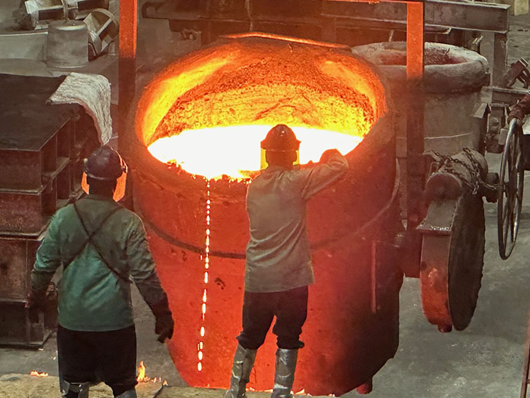 Willman Industries foundry workers pouring molten iron